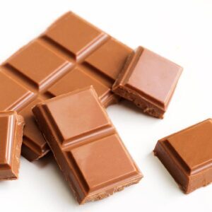 Squares of milk chocolate on a white background